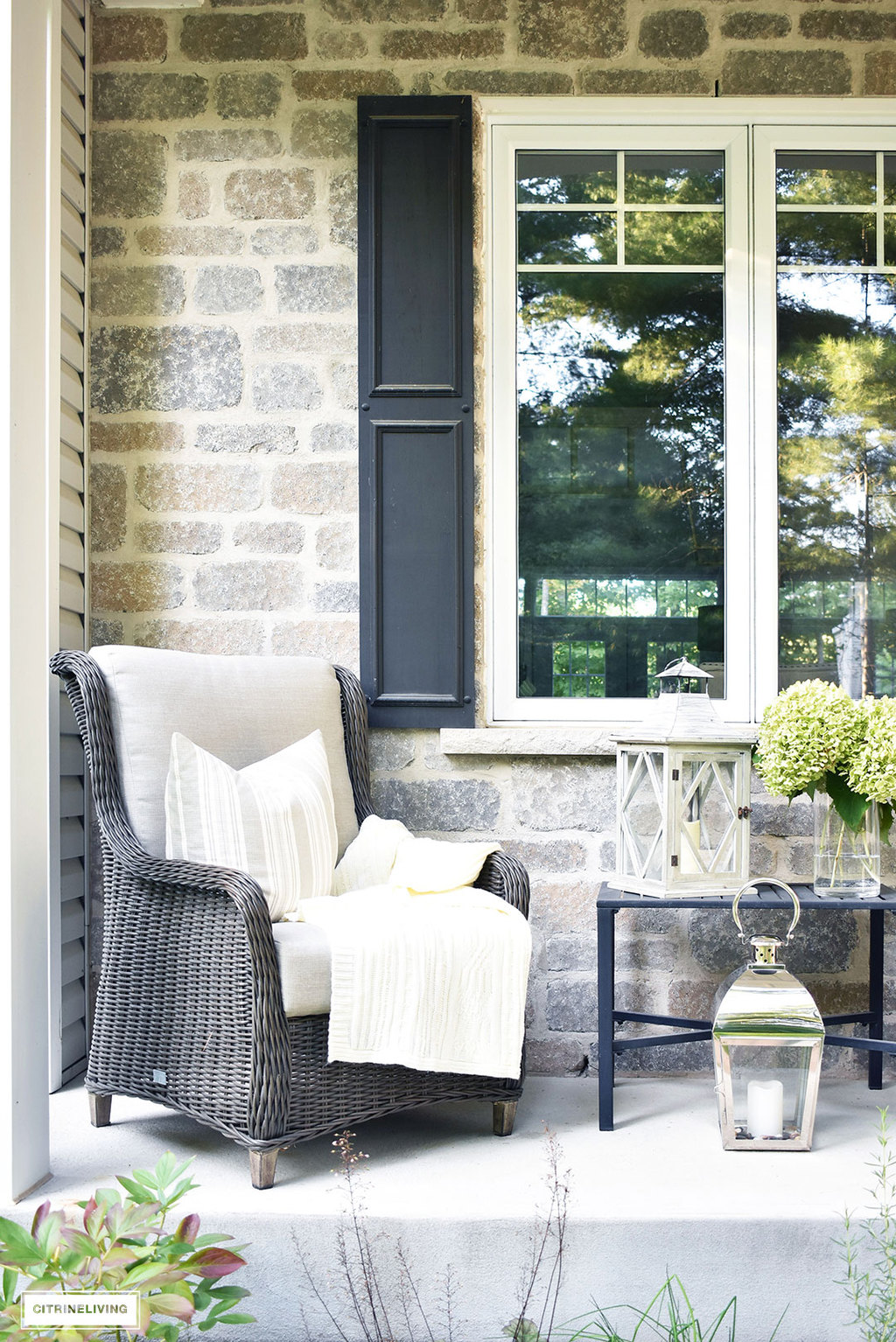 Create a cozy seating nook on your front porch this Fall, layered with blankets, fresh hydrangeas and lanterns.