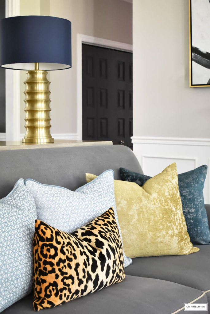 Fall Home Tour with navy and gold velvet pillows and accents. Brass lighting and leopard pillow.