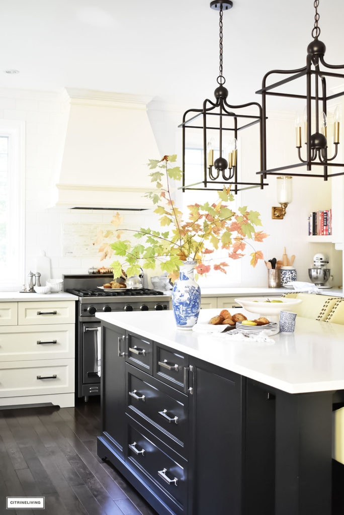 Fall Home Tour - casual elegant black and white kitchen with large black island and lantern style pendant lighting.