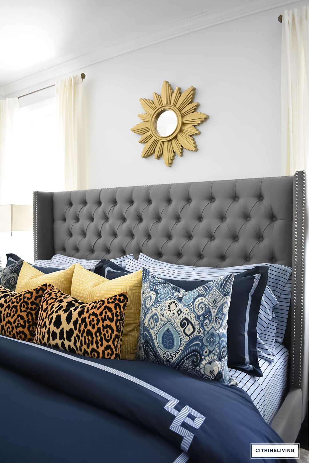 Gorgeous Blue Fall master bedroom - A masculine meets glam look with navy blue, stripes, paisley ikat, greek key, leopard and gold - perfectly tailored and chic!