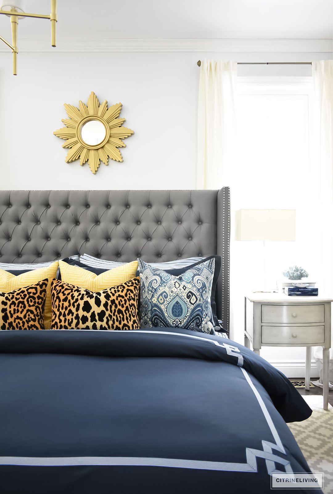 Gorgeous Blue Fall master bedroom - A masculine meets glam look with navy blue, stripes, paisley ikat, greek key, leopard and gold - perfectly tailored and chic!