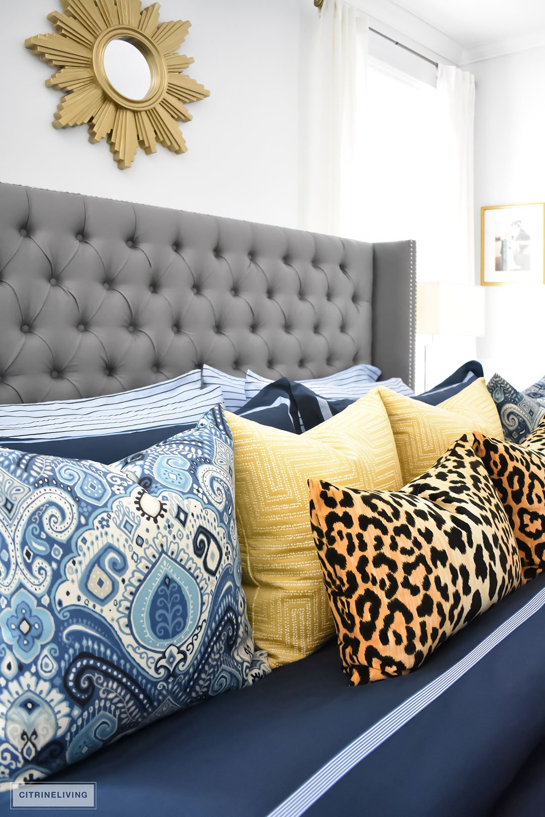 Gorgeous Blue Fall master bedroom - A masculine meets glam look with navy blue, stripes, paisley ikat, greek key, leopard and gold - perfectly tailored and chic!