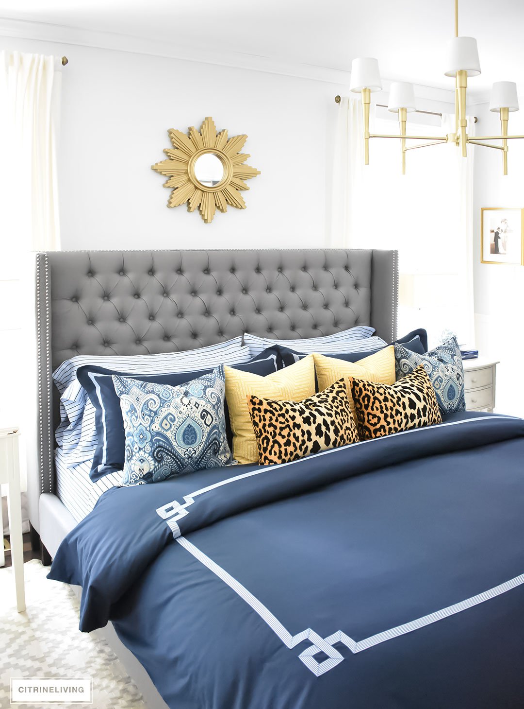 Gorgeous Blue Fall master bedroom - A masculine meets glam look with navy blue, stripes, paisley ikat, greek key, leopard and gold - perfectly tailored and chic!