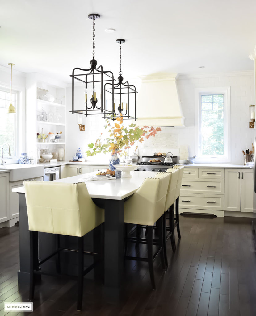 Fall Home Tour - casual elegant black and white kitchen with large black island and lantern style pendant lighting.