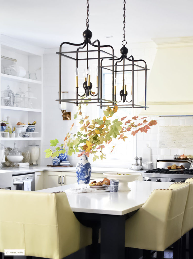 Fall Home Tour - casual elegant black and white kitchen with large black island and lantern style pendant lighting. Blue and white vases and Fall foliage.