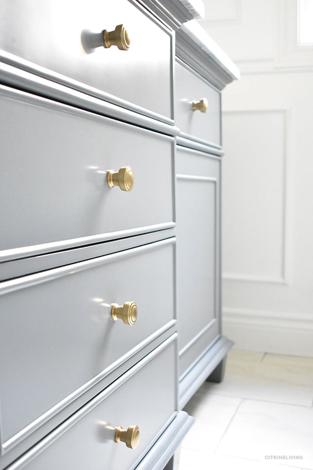 Gorgeous grey, brass and white master bathroom featuring this standout vanity sure to make a statement in any bathroom!