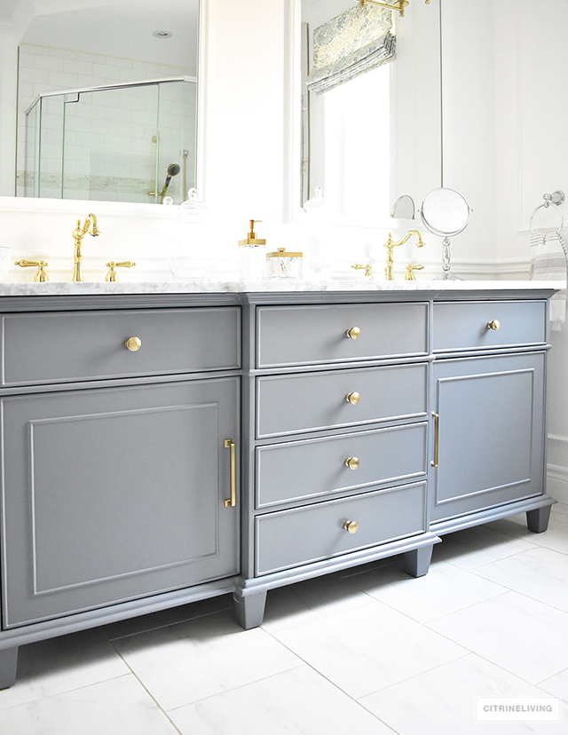 Gorgeous grey, brass and white master bathroom featuring this standout vanity sure to make a statement in any bathroom!