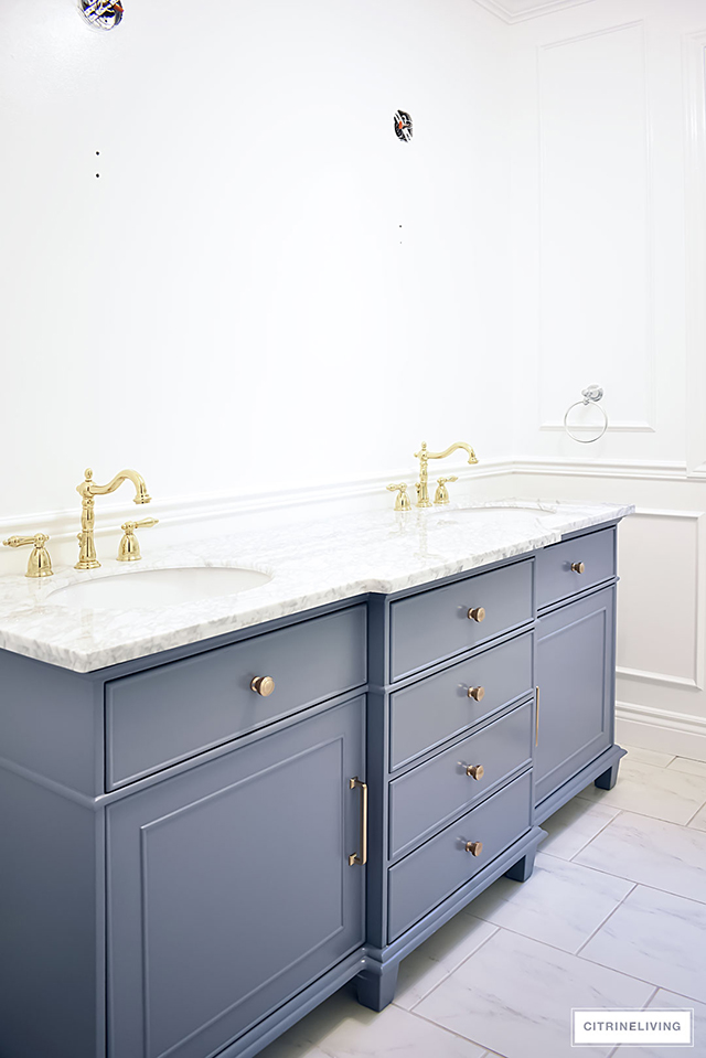 Our master bath makeover is almost finished! Gorgeous details - wall panelling, brass lighting + fixtures, custom window treatment and so much more!