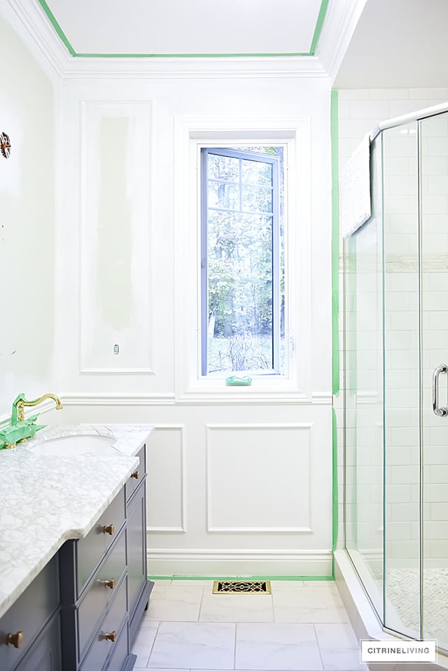 Our master bath makeover is almost finished! Gorgeous details - wall panelling, brass lighting + fixtures, custom window treatment and so much more!