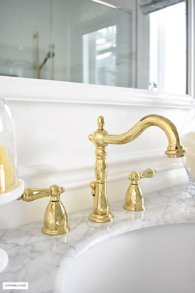 Gorgeous traditional meets modern master bathroom reveal with an elegant color palette of grey, white and brass, accented with blue and white chinoiserie.