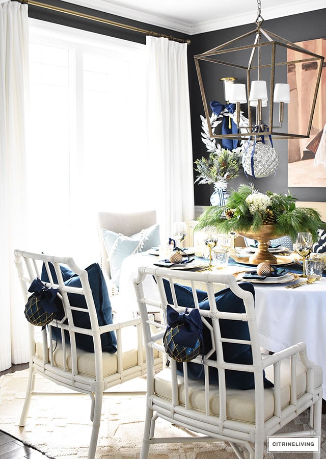 Gorgeous Christmas tablescape with classic navy and green tartan, accented with gold ornaments, chargers, flatware and glassware.