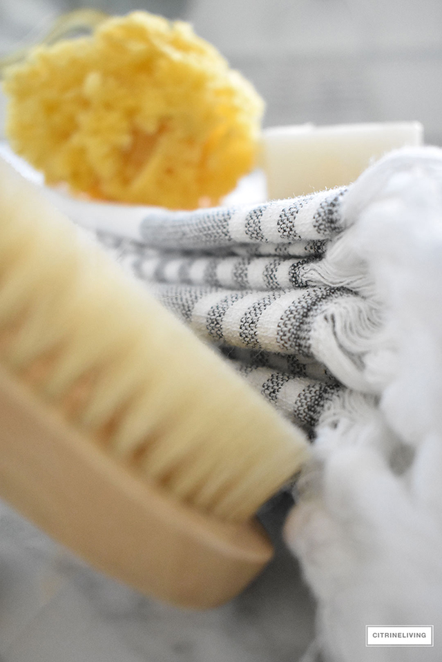 Gorgeous master bathroom makeover featuring marble, brass and beautiful accessories.