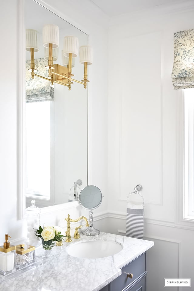 Gorgeous traditional meets modern master bathroom reveal with an elegant color palette of grey, white and brass, accented with blue and white chinoiserie.