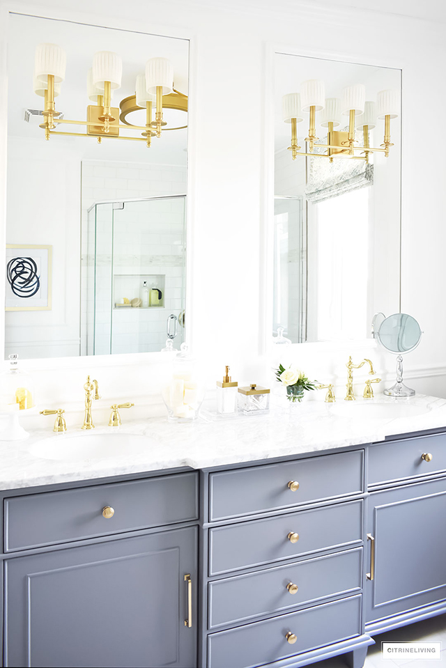 Gorgeous traditional meets modern master bathroom reveal with an elegant color palette of grey, white and brass, accented with blue and white chinoiserie.