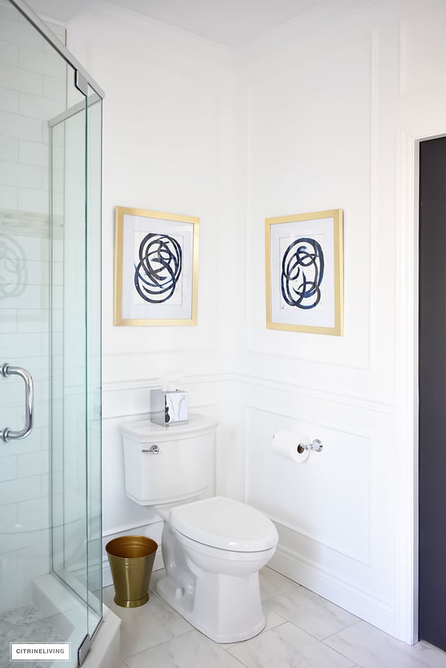 Gorgeous traditional meets modern master bathroom reveal with an elegant color palette of grey, white and brass, accented with blue and white chinoiserie.