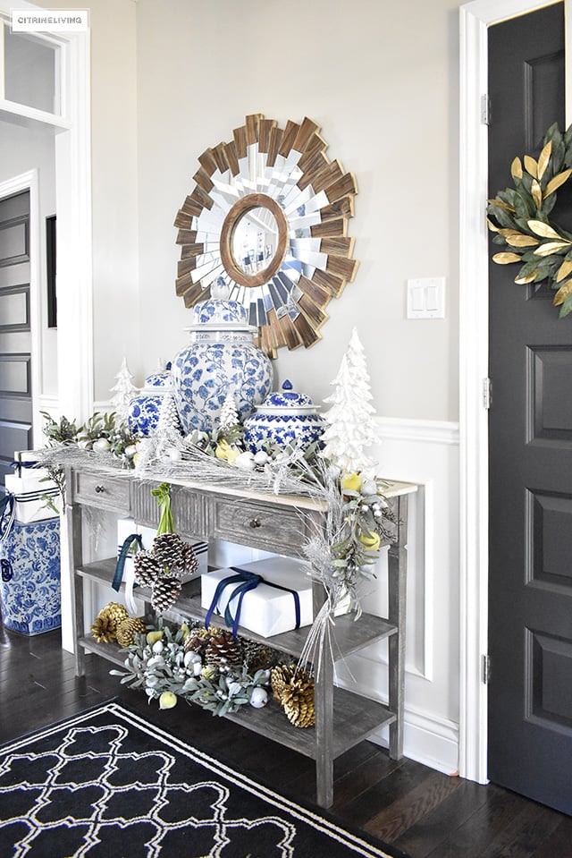 Beautiful Christmas home tour featuring the dining room and entryway dressed in blue, white, green and gold for the perfect holiday mix.