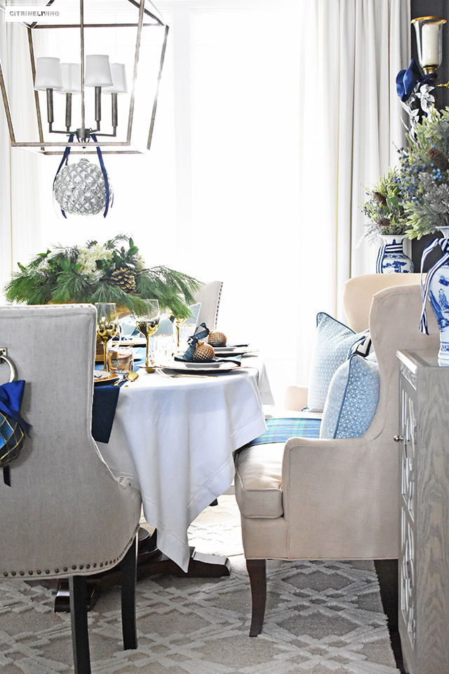 Beautiful Christmas home tour featuring the dining room and entryway dressed in blue, white, green and gold for the perfect holiday mix.