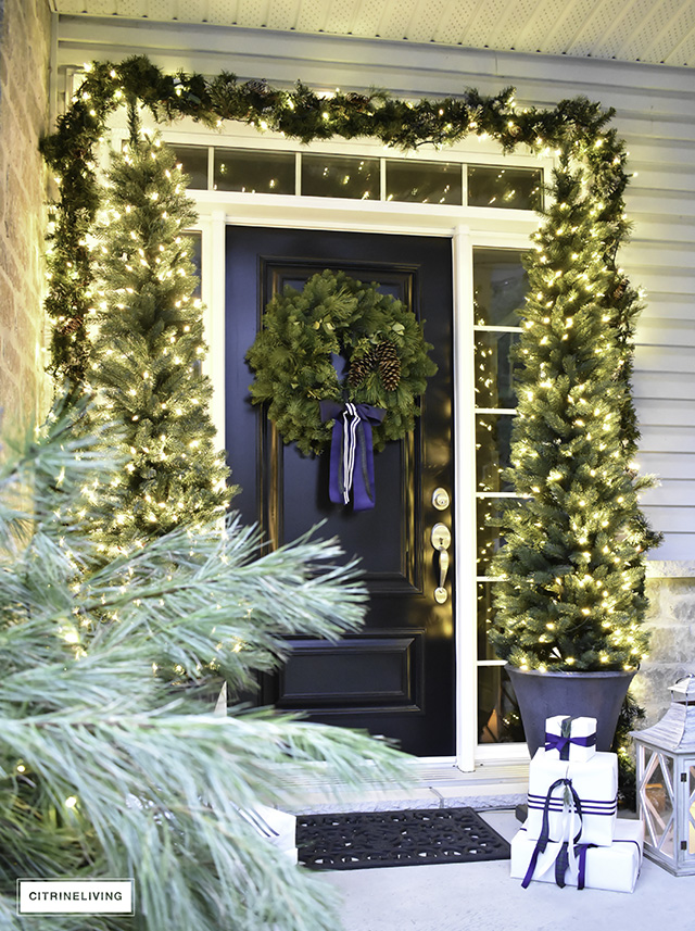 Set a magical scene and welcome your guests on your Christmas front porch this year with fresh greenery and the twinkle of white lights.