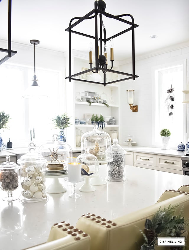 A beautiful Christmas kitchen with blue and white chinoiserie, paired with holiday greenery for a sophisticated, festive and elegant look.