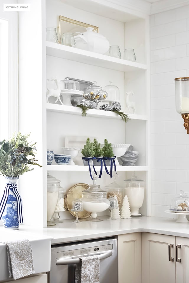 A beautiful Christmas kitchen with blue and white chinoiserie, paired with holiday greenery for a sophisticated, festive and elegant look.