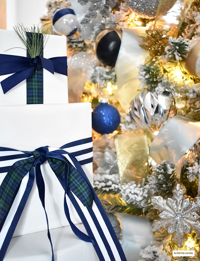 Beautiful, flocked Christmas tree adorned with navy, light blue and elegant metallics, is sophisticated and refreshing for your holiday decor.