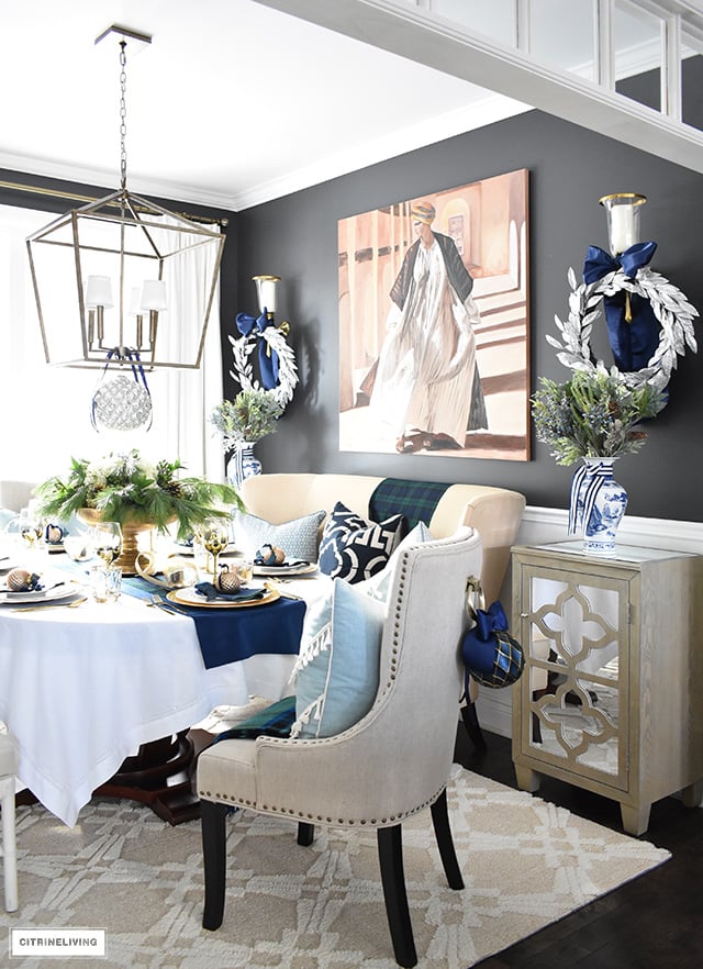 Beautiful Christmas home tour featuring the dining room and entryway dressed in blue, white, green and gold for the perfect holiday mix.