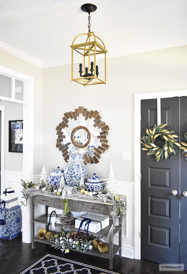 Beautiful Christmas home tour featuring the dining room and entryway dressed in blue, white, green and gold for the perfect holiday mix.