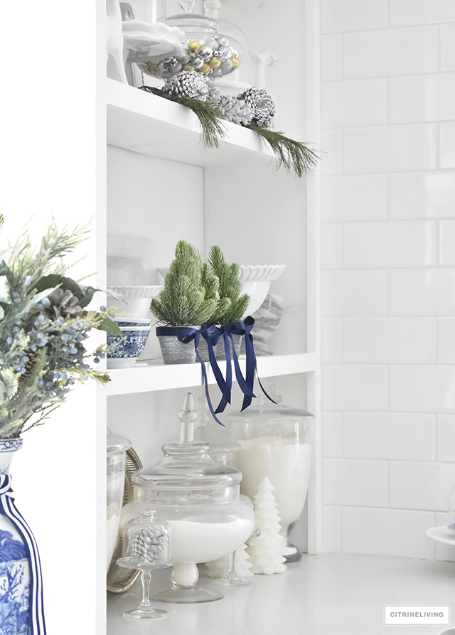 A beautiful Christmas kitchen with blue and white chinoiserie, paired with holiday greenery for a sophisticated, festive and elegant look.