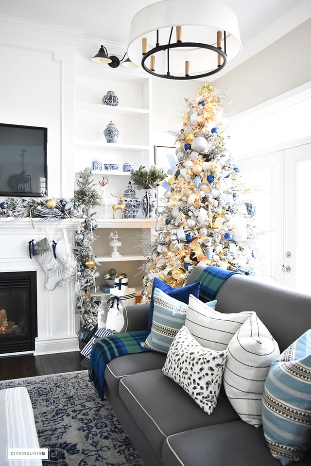 Christmas Home Tour - Gorgeous living room dressed in blues, gold, silver and flocked greenery is sophisticated,elegant and has an elevated look and feel.