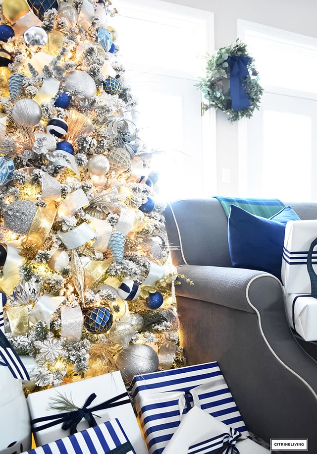 Beautiful, flocked Christmas tree adorned with navy, light blue and elegant metallics, is sophisticated and refreshing for your holiday decor.