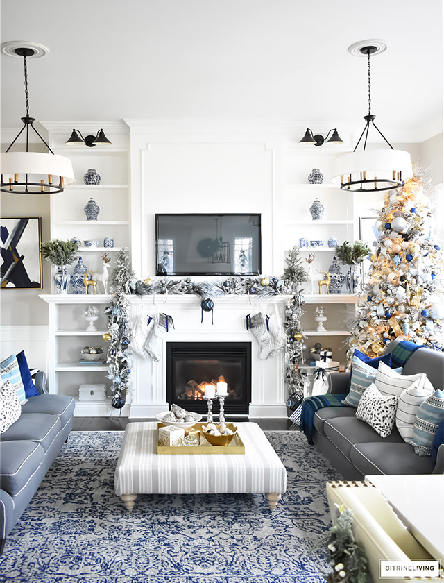 Christmas Home Tour - Gorgeous living room dressed in blues, gold, silver and flocked greenery is sophisticated,elegant and has an elevated look and feel.