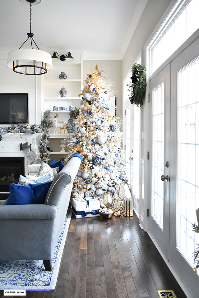 Beautiful, flocked Christmas tree adorned with navy, light blue and elegant metallics, is sophisticated and refreshing for your holiday decor.