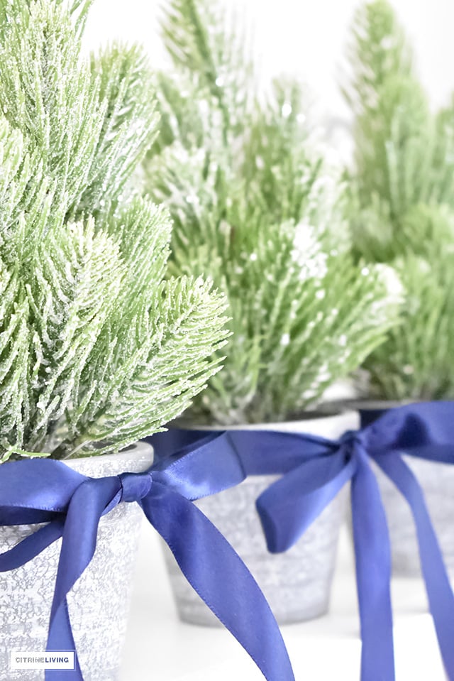 A beautiful Christmas kitchen with blue and white chinoiserie, paired with holiday greenery for a sophisticated, festive and elegant look.