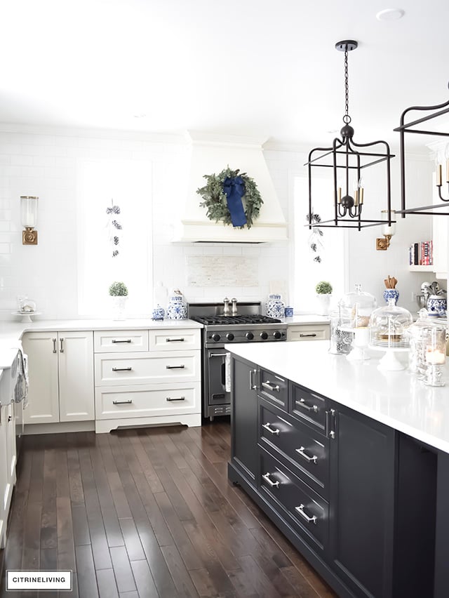 A beautiful Christmas kitchen with blue and white chinoiserie, paired with holiday greenery for a sophisticated, festive and elegant look.