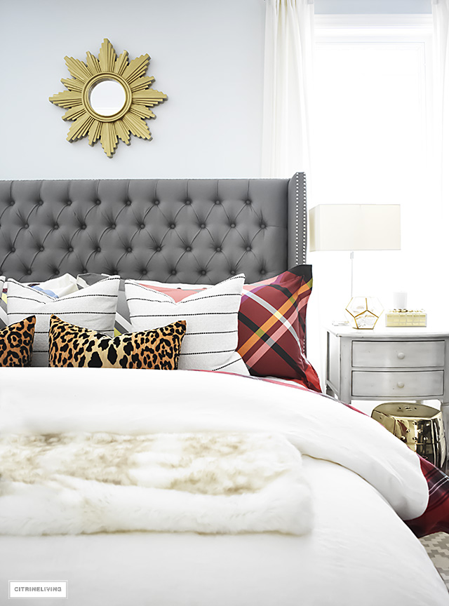 Gorgeous red and white tartan bedding from Williams-Sonoma paired with leopard and stripes is festive and cozy for the holidays and winter season.