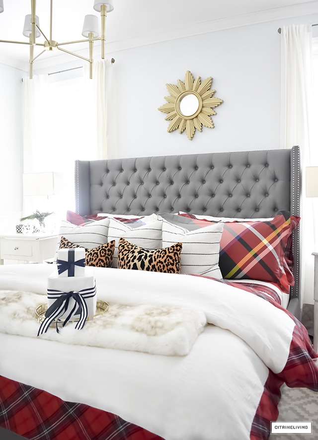 Gorgeous red and white tartan bedding from Williams-Sonoma paired with leopard and stripes is festive and cozy for the holidays and winter season.