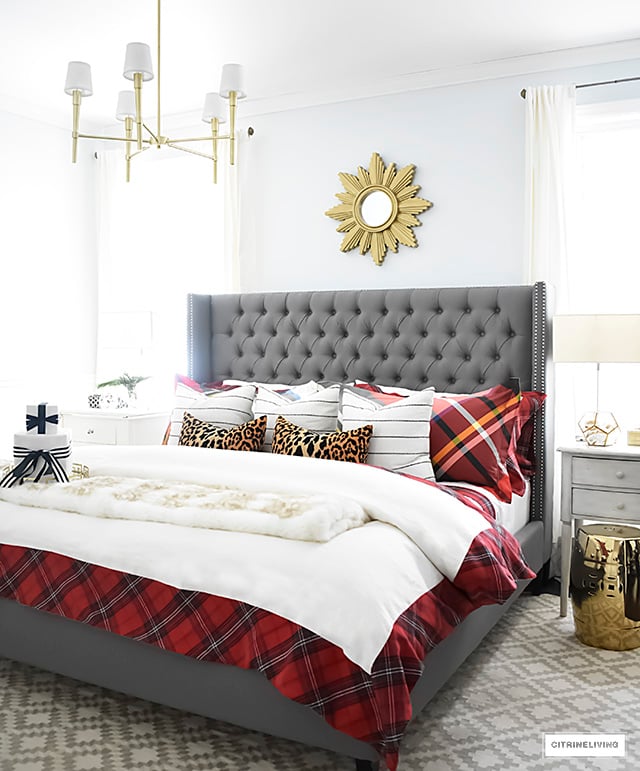 Gorgeous red and white tartan bedding from Williams-Sonoma paired with leopard and stripes is festive and cozy for the holidays and winter season.