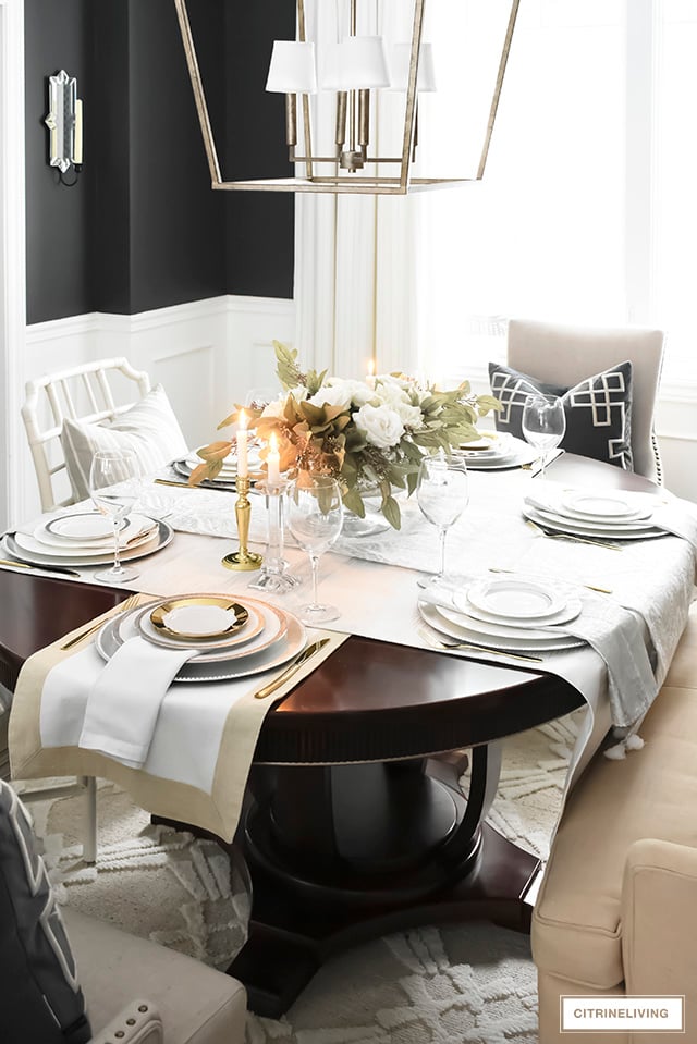 A gorgeous neutral Valentine's table with tones of white layered with metallic accents and a beautiful white rose centrepiece.