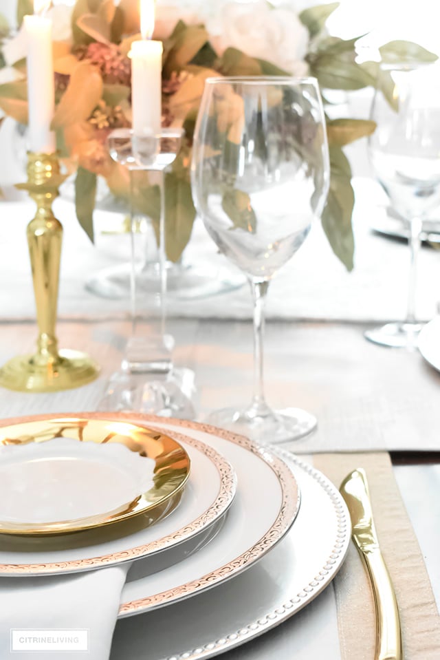 A gorgeous neutral Valentine's table with tones of white layered with metallic accents and a beautiful white rose centrepiece.