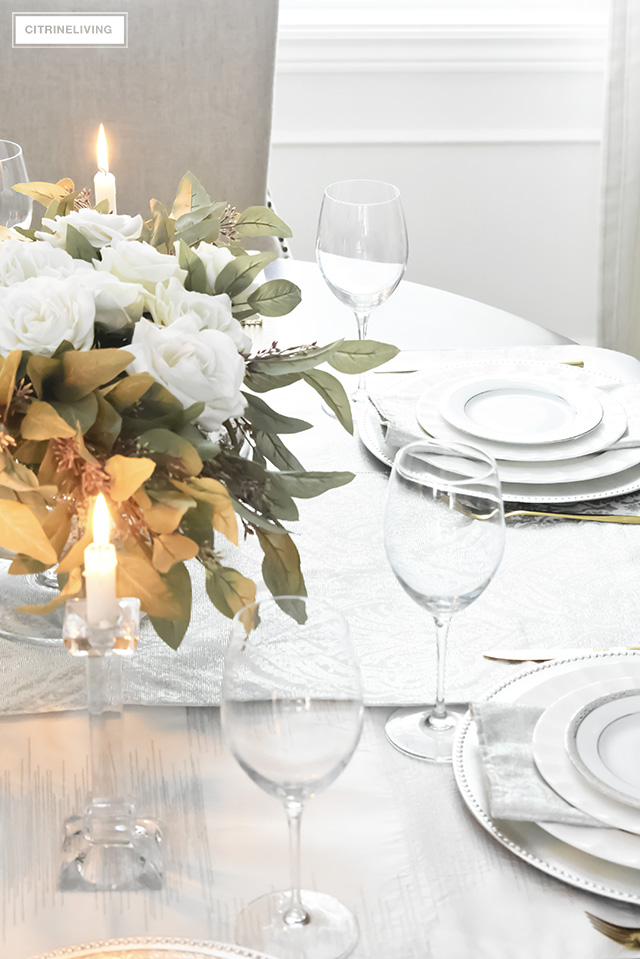 A gorgeous neutral Valentine's table with tones of white layered with metallic accents and a beautiful white rose centrepiece.