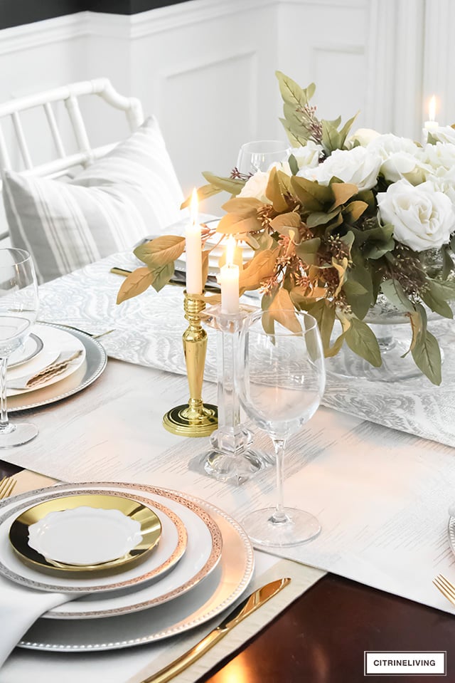 A gorgeous neutral Valentine's table with tones of white layered with metallic accents and a beautiful white rose centrepiece.