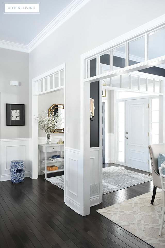 A light and bright entryway makeover that was super simple to achieve! Some chalk paint, a new mirror and new rug have completely transformed this foyer!