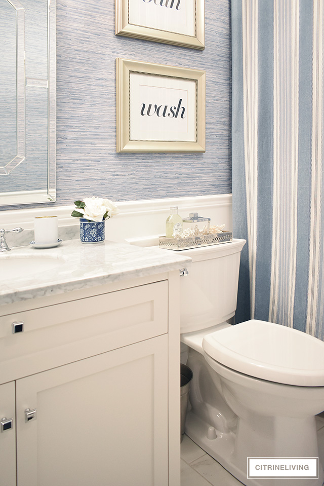 Our kids' bathroom gets a chic, coastal update with a classic white vanity and marble countertop for an elegant and traditional look.