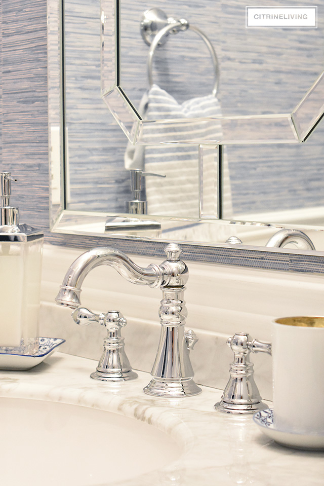 Our kids' bathroom gets a chic, coastal update with a classic white vanity and marble countertop for an elegant and traditional look.