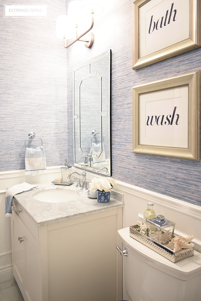 Our kids' bathroom gets a chic, coastal update with a classic white vanity and marble countertop for an elegant and traditional look.