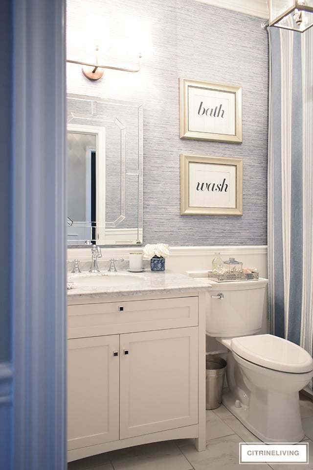 Our kids' bathroom gets a chic, coastal update with a classic white vanity and marble countertop for an elegant and traditional look.