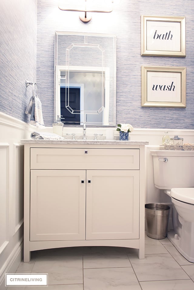 Our kids' bathroom gets a chic, coastal update with a classic white vanity and marble countertop for an elegant and traditional look.