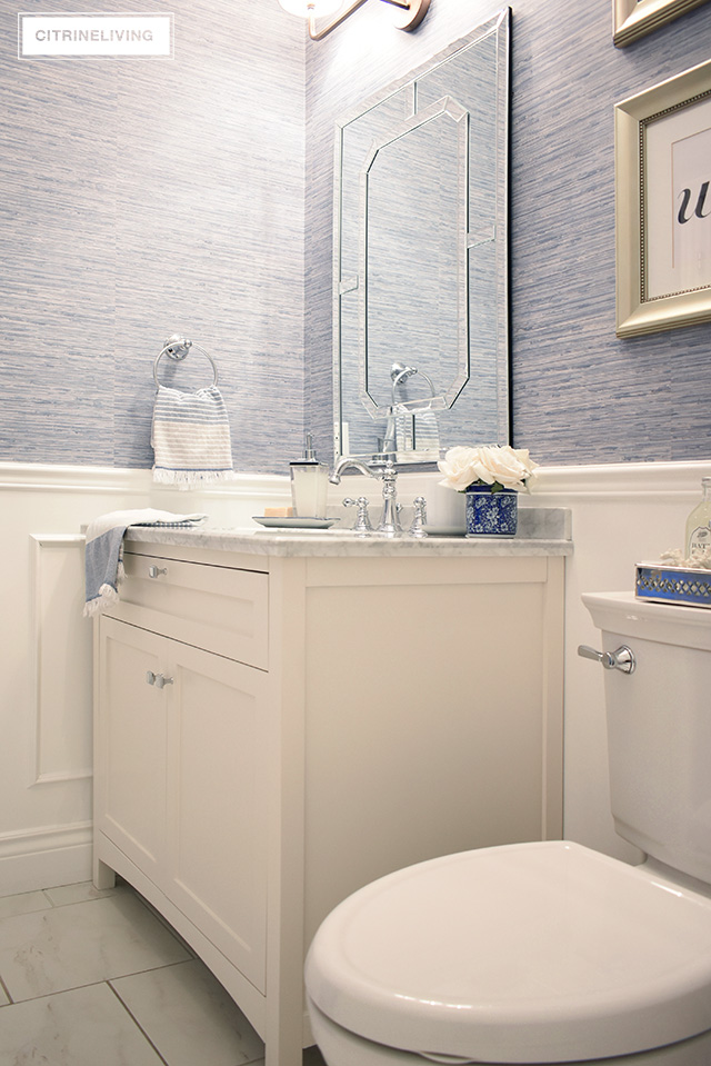 Our kids' bathroom gets a chic, coastal update with a classic white vanity and marble countertop for an elegant and traditional look.