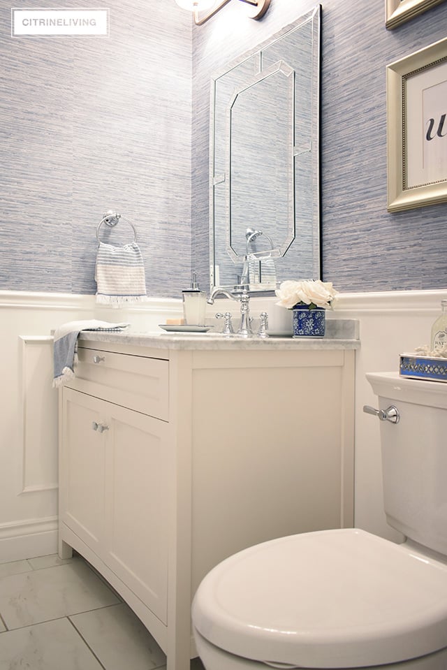 Our kids' bathroom gets a chic, coastal update with a classic white vanity and marble countertop for an elegant and traditional look.