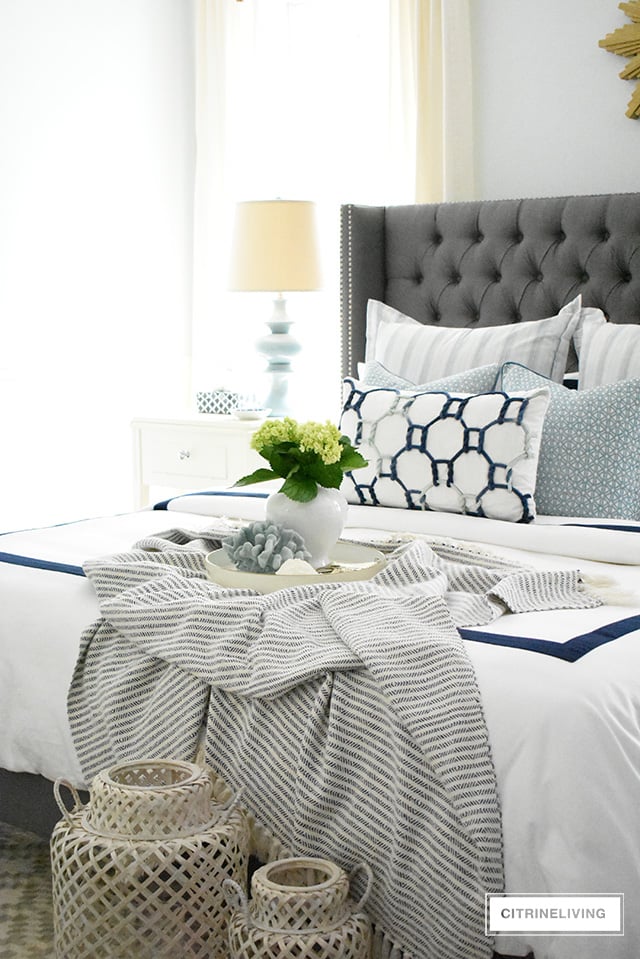 Adding summer touches to your bedroom is as simple as throw pillows, a casual throw, and some pretty coastal accents. Bring in the season with these these no-fail tips for a relaxing and airy summer bedroom!